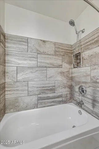 a bathroom with a bathtub and shower