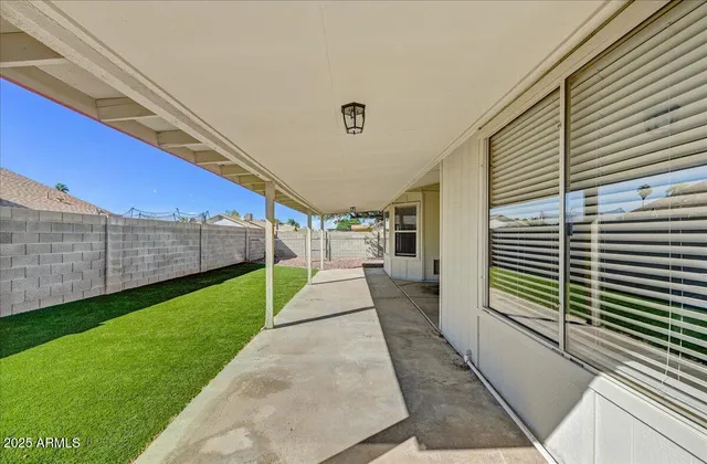 a view of a backyard with sitting area