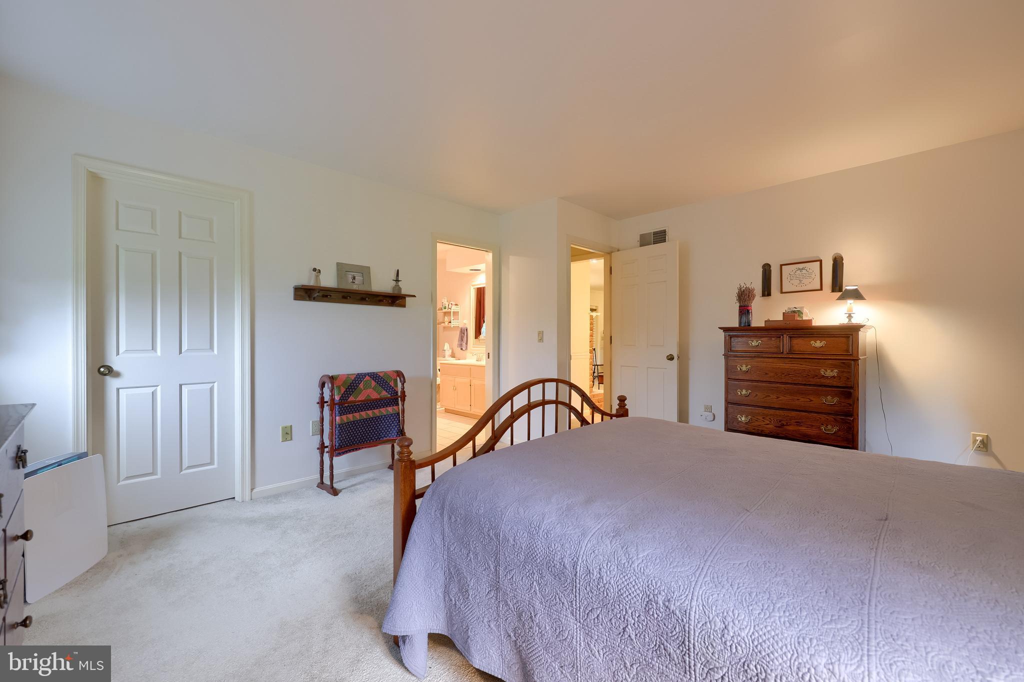 100 Olde Field Drive Lititz, PA 17543 - Photo 41 of 63 a bedroom with a bed and dresser with mirror