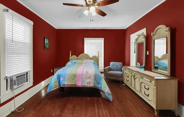 a living room with furniture and two windows