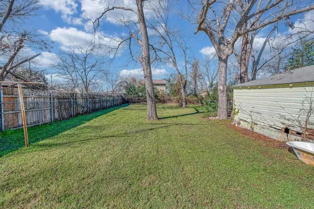 a view of a park with large trees