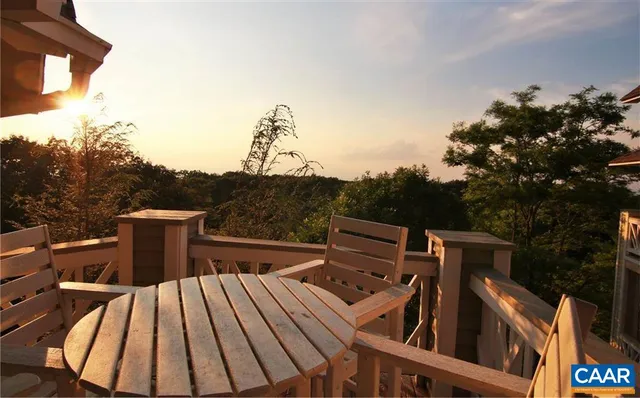 a view of a roof deck with couches and wooden floor