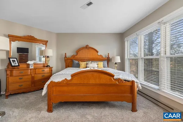 a bedroom with a bed and a mirror