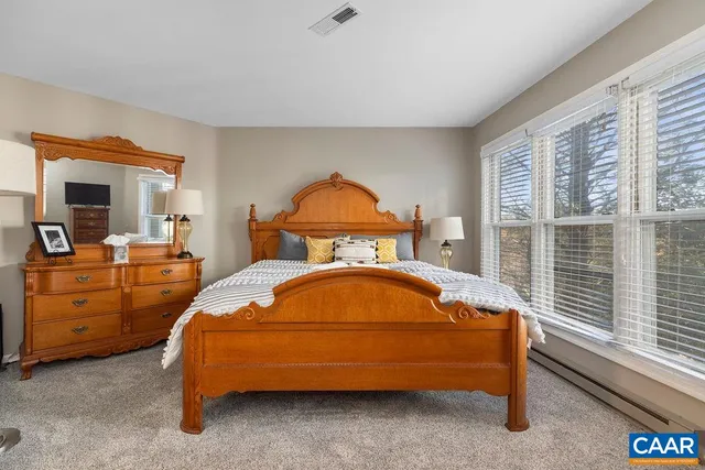 a bedroom with a bed and a mirror