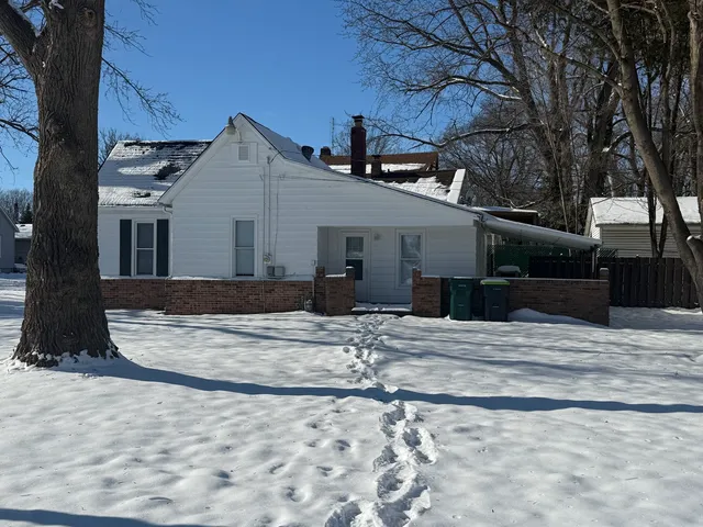a view of a house with snow on the road