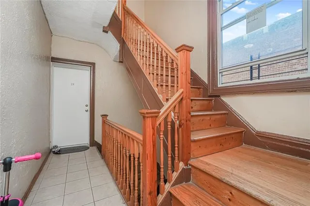 a view of entryway and hall with wooden floor