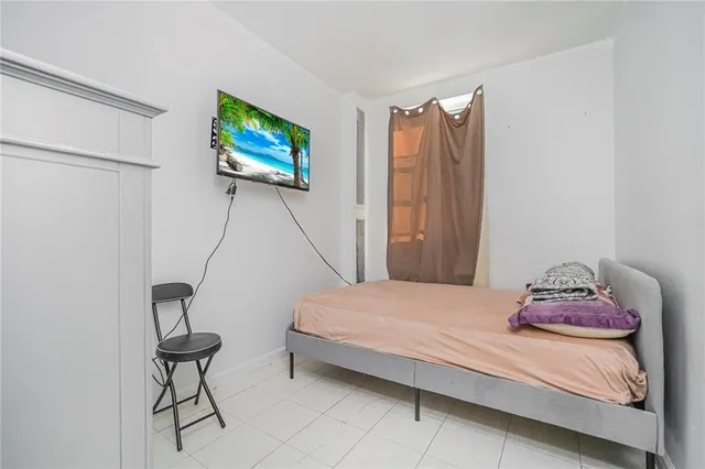 a bedroom with a bed and a chair