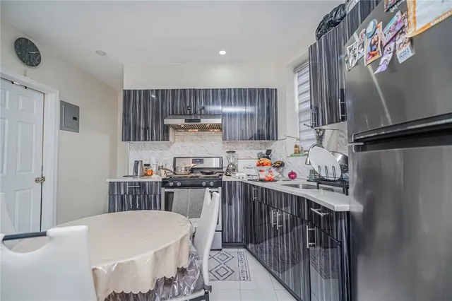 a kitchen with a sink a stove and refrigerator