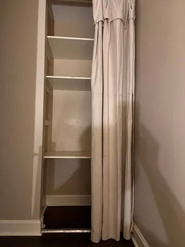 a view of walk in closet with rug