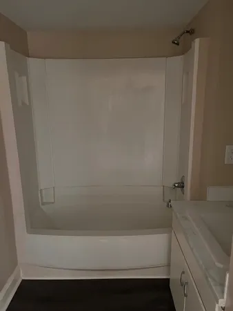 a bathroom with a bathtub and a shower
