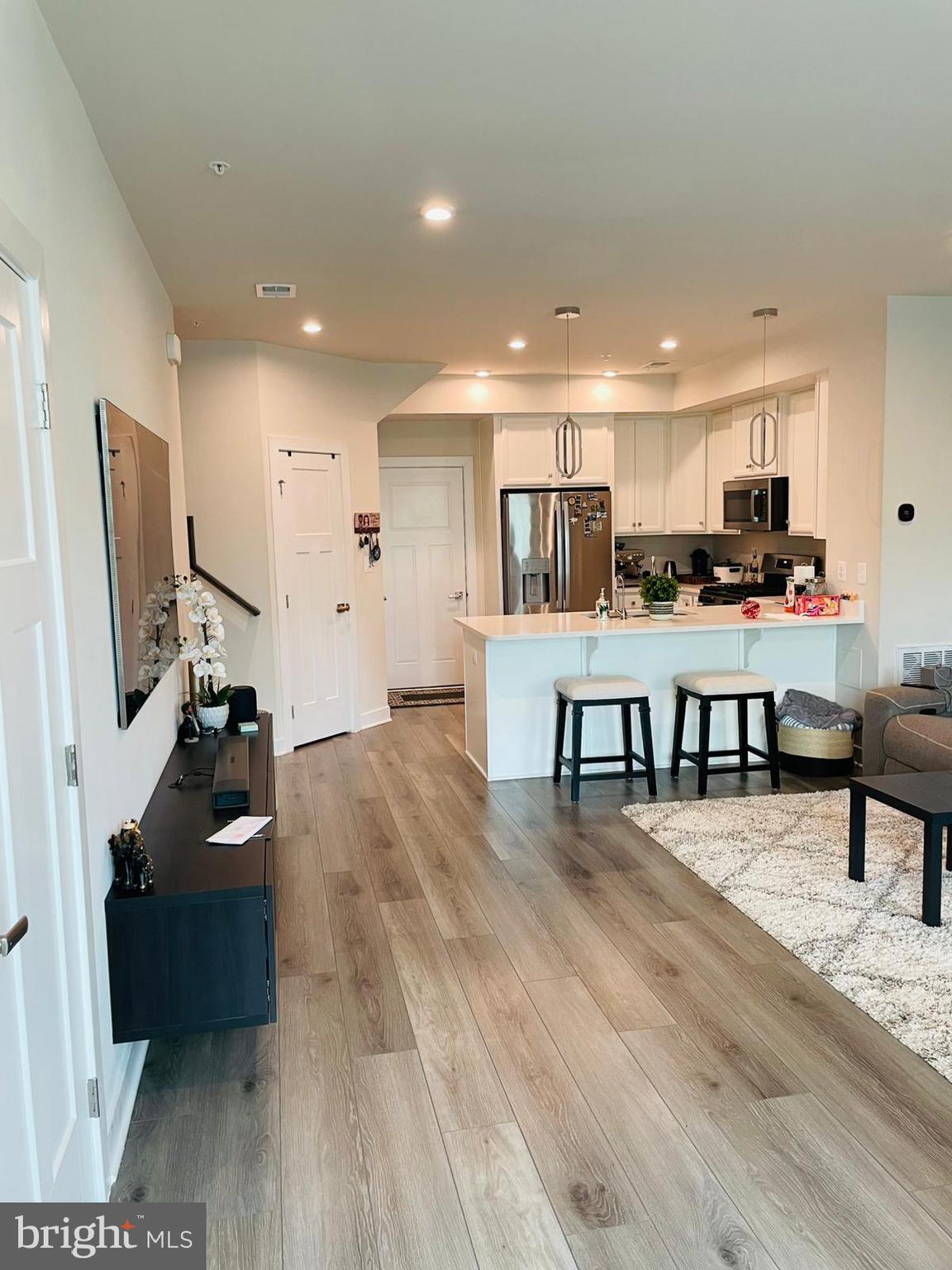 24260 Thurso Square Sterling, VA 20166 - Photo 3 of 16 a living room with furniture and a flat screen tv