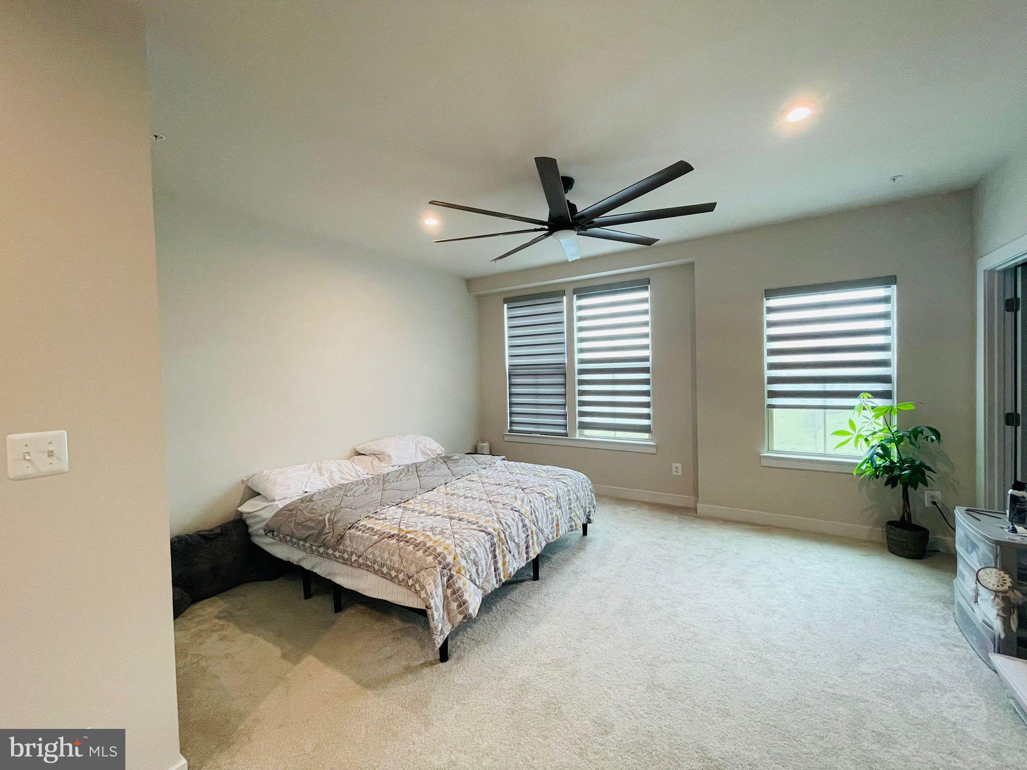 24260 Thurso Square Sterling, VA 20166 - Photo 6 of 16 a spacious bedroom with a bed and a large window