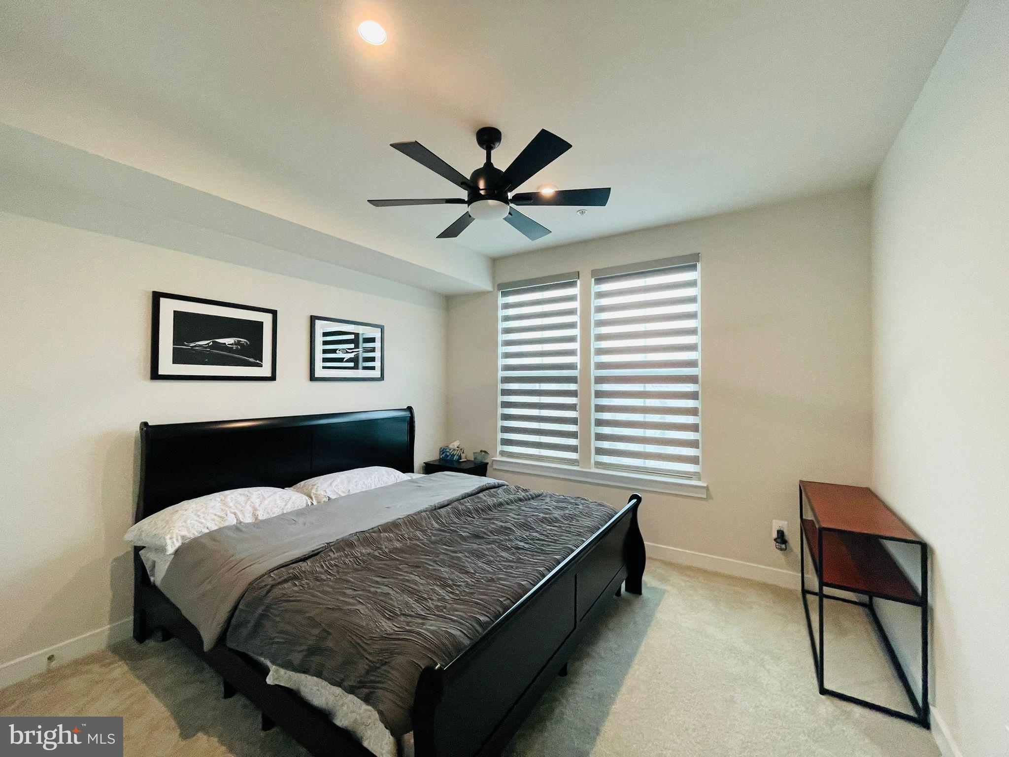 24260 Thurso Square Sterling, VA 20166 - Photo 7 of 16 a bedroom with a bed and a chandelier