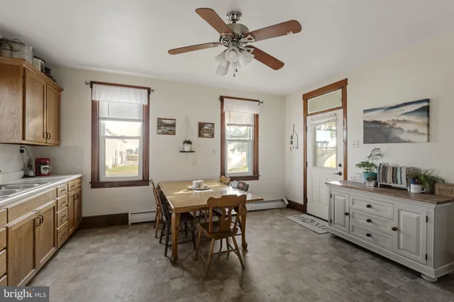 a kitchen with cabinets table and chairs