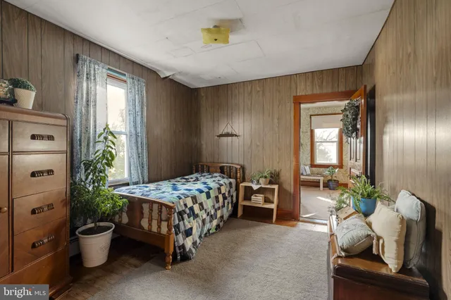 a bedroom with a bed and a couch