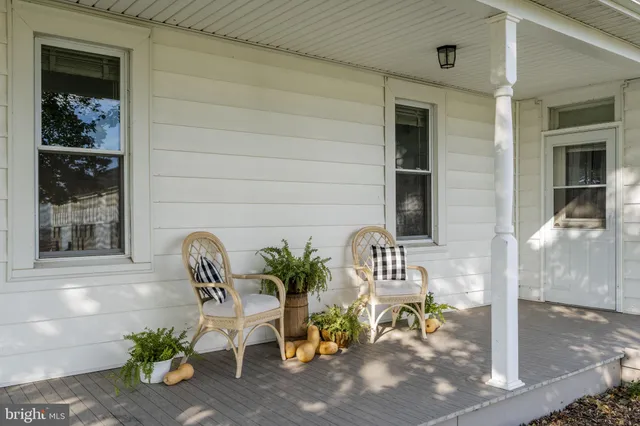 a view of balcony with two chairs and a potted plant