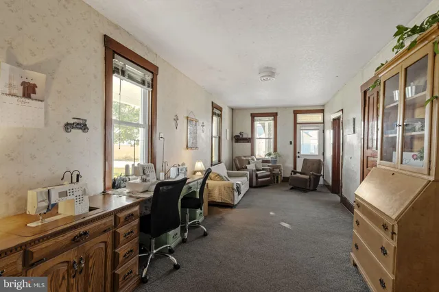 a room with furniture and two windows