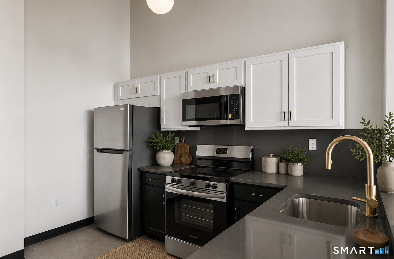 480 Myrtle Street, Unit 402 New Britain, CT 06053 - Photo 2 of 17 a kitchen with white cabinets and stainless steel appliances