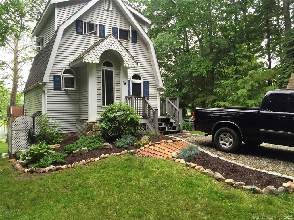 a front view of a house with a garden
