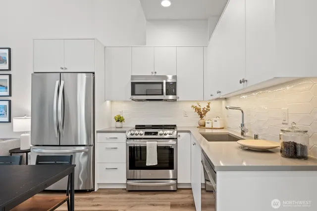 a kitchen with a stove a sink and a refrigerator