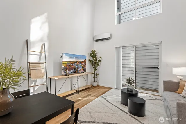 a bedroom with a bed and a table with potted plants