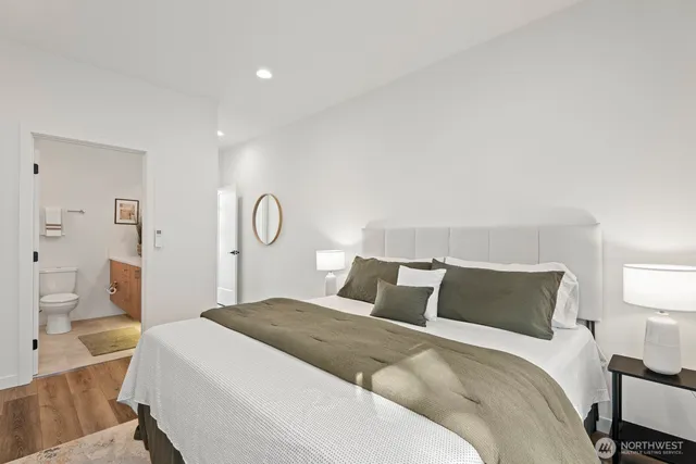 a bedroom with a bed and a lamp