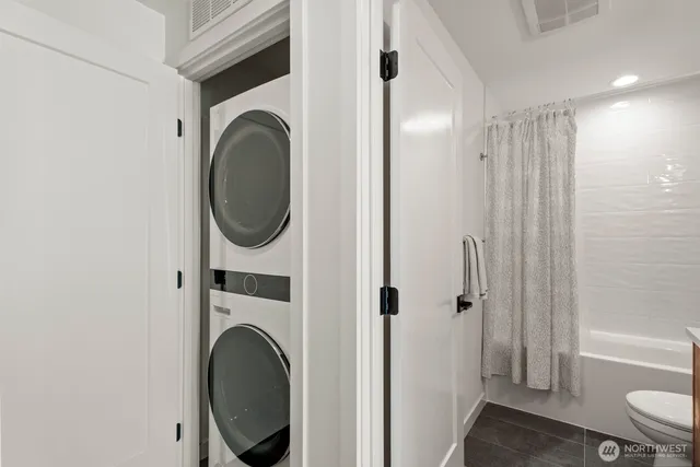 a view of a hallway with washer and dryer