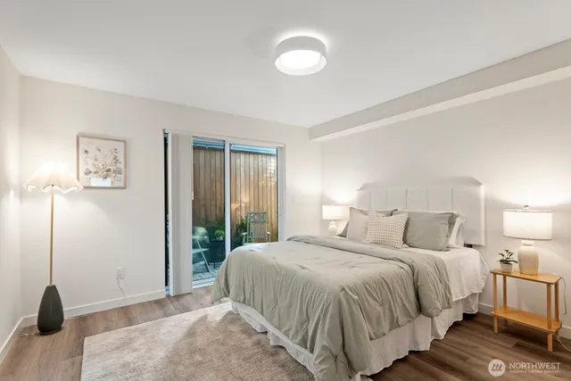 a bedroom with a bed and a night stand