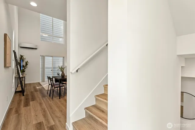 a view of entryway and hall with wooden floor