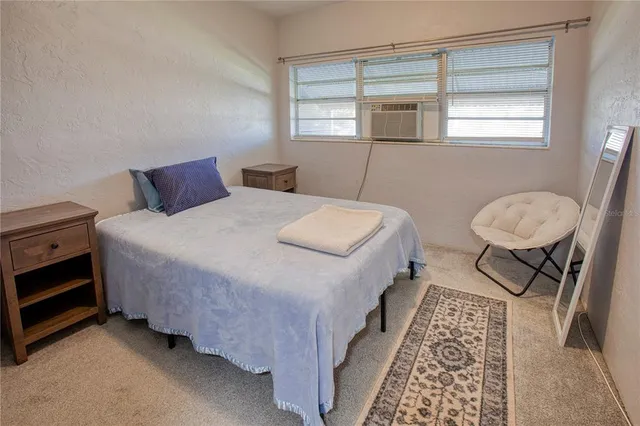 a view of a lake with a bench and trees around