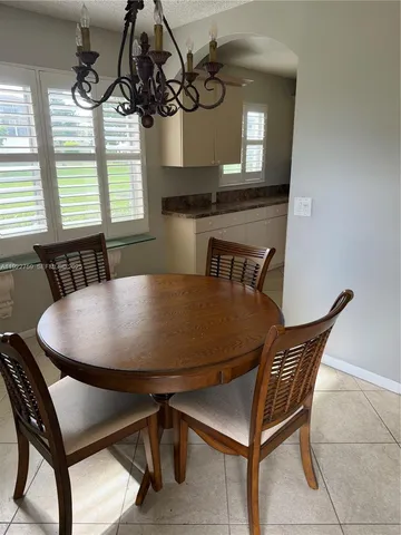 a view of a dining room with furniture and window