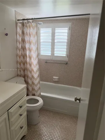 a bathroom with a toilet a sink and a bathtub