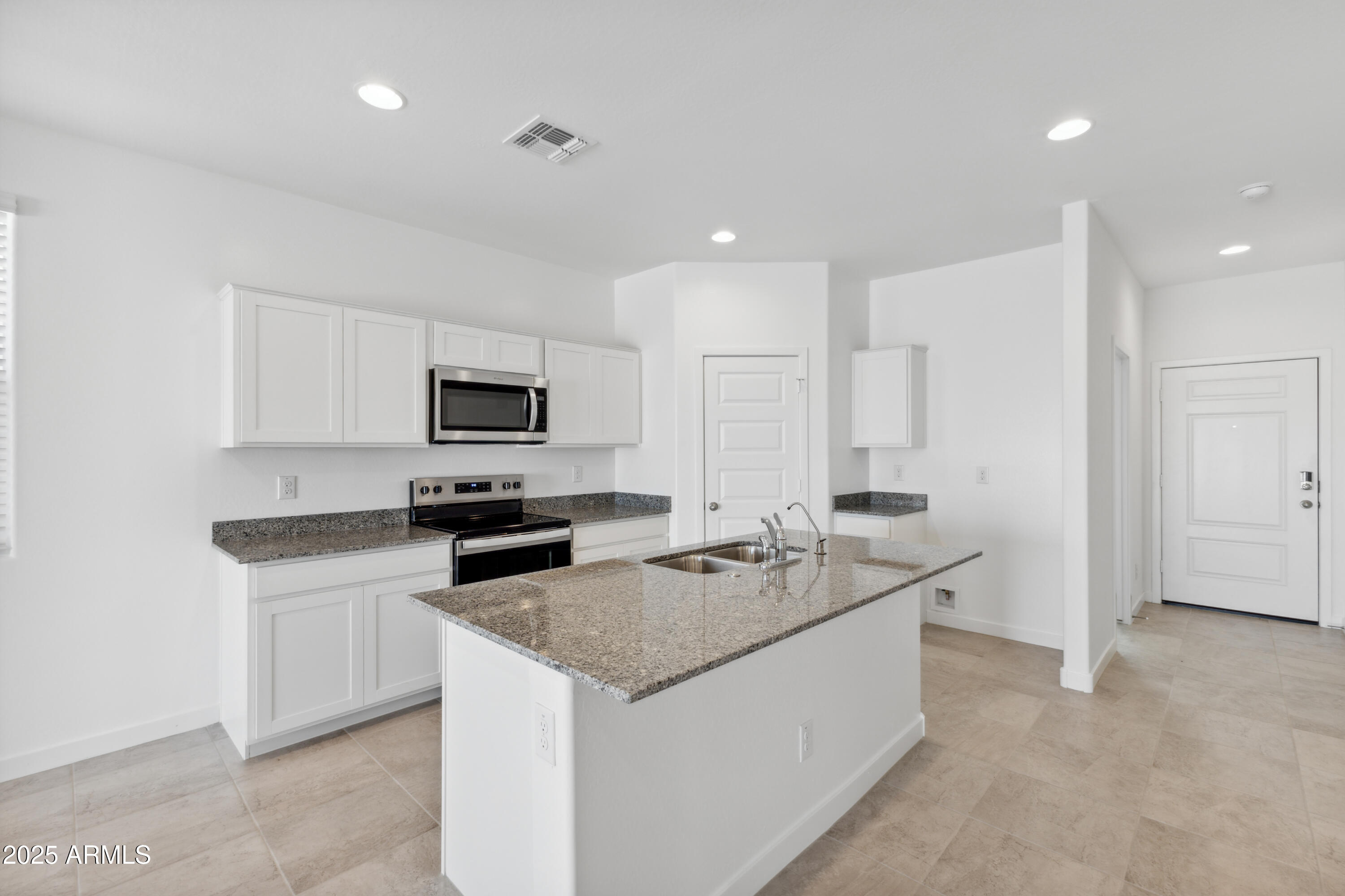 a kitchen that has a sink and a stove in it