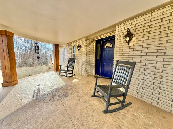a living room with furniture a dining table and paintings on the wall
