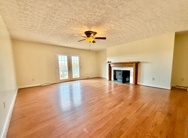 a kitchen with stainless steel appliances granite countertop a stove top oven a sink with island and chairs