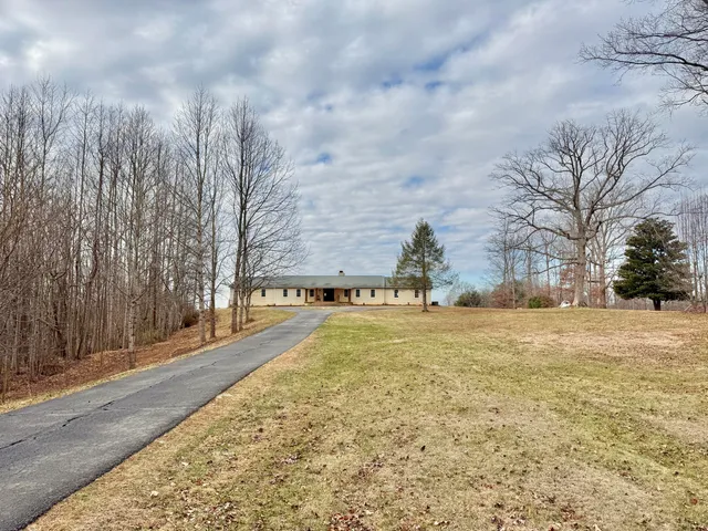 a living room with furniture a dining table and paintings on the wall