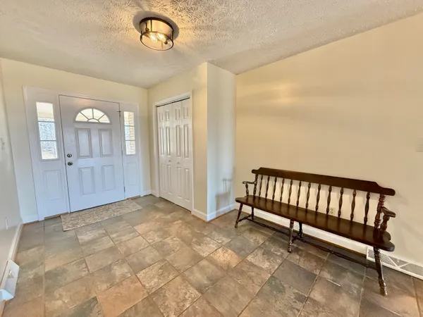 a view of a livingroom with furniture and a window