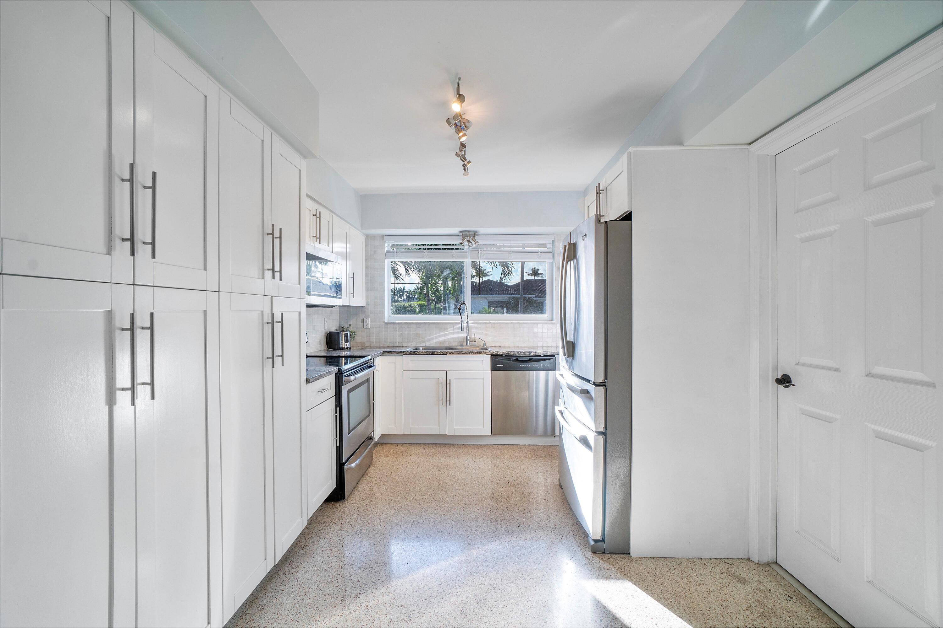 2900 Spanish River Road Boca Raton, FL 33432 - Photo 14 of 25 a kitchen with a refrigerator and a sink