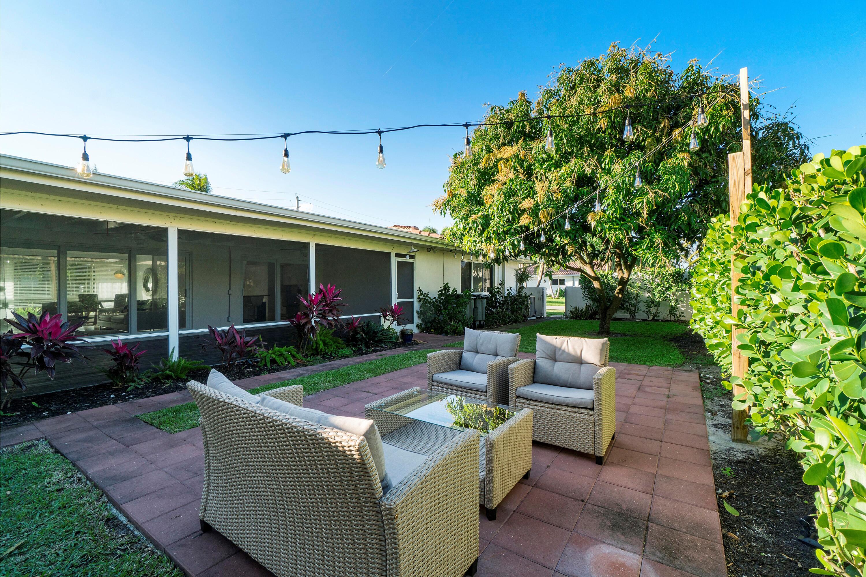 2900 Spanish River Road Boca Raton, FL 33432 - Photo 22 of 25 a view of a house with backyard sitting area and garden