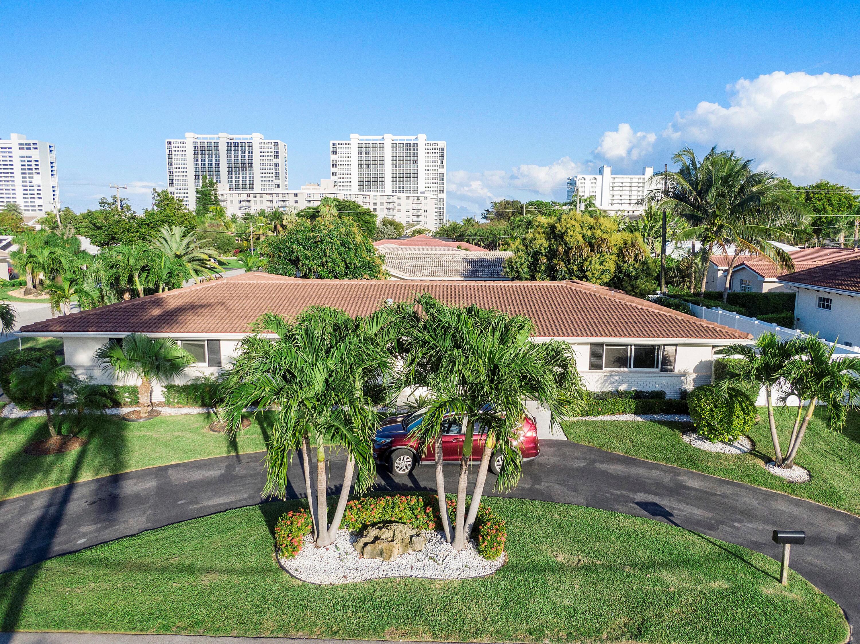 2900 Spanish River Road Boca Raton, FL 33432 - Photo 3 of 25 a front view of a house with a yard