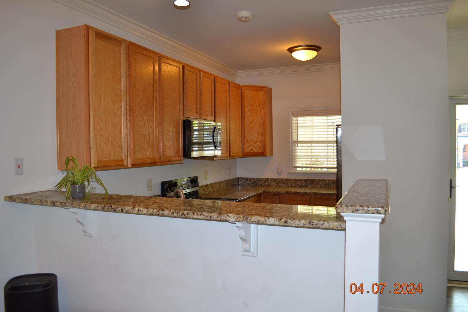 4506 Mistiflower Drive Raleigh, NC 27606 - Photo 10 of 27 a kitchen with a sink and a window