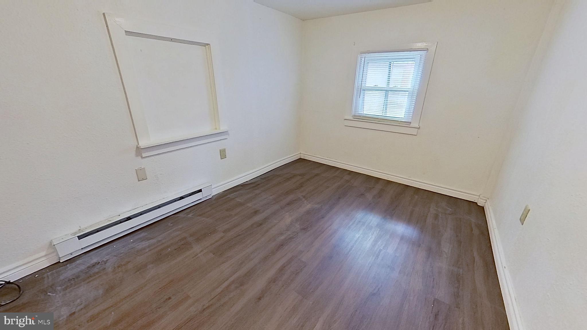28 East Maple Street Dallastown, PA 17313 - Photo 6 of 6 an empty room with wooden floor and windows
