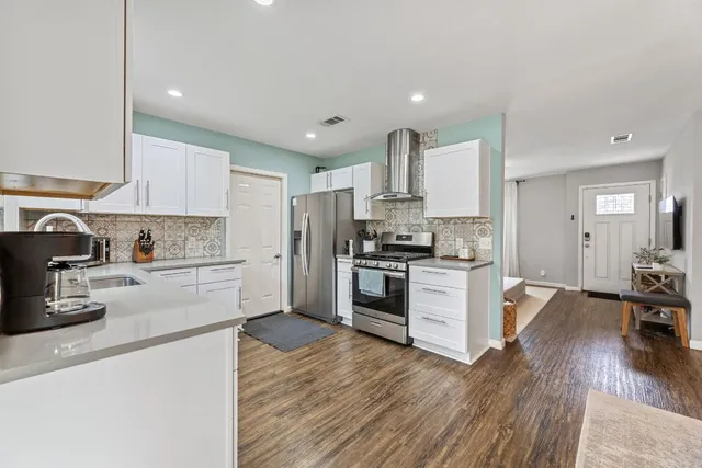 a kitchen with granite countertop stainless steel appliances and wooden cabinets