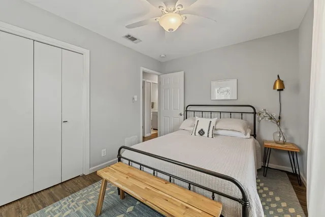 a bedroom with a bed and a chandelier