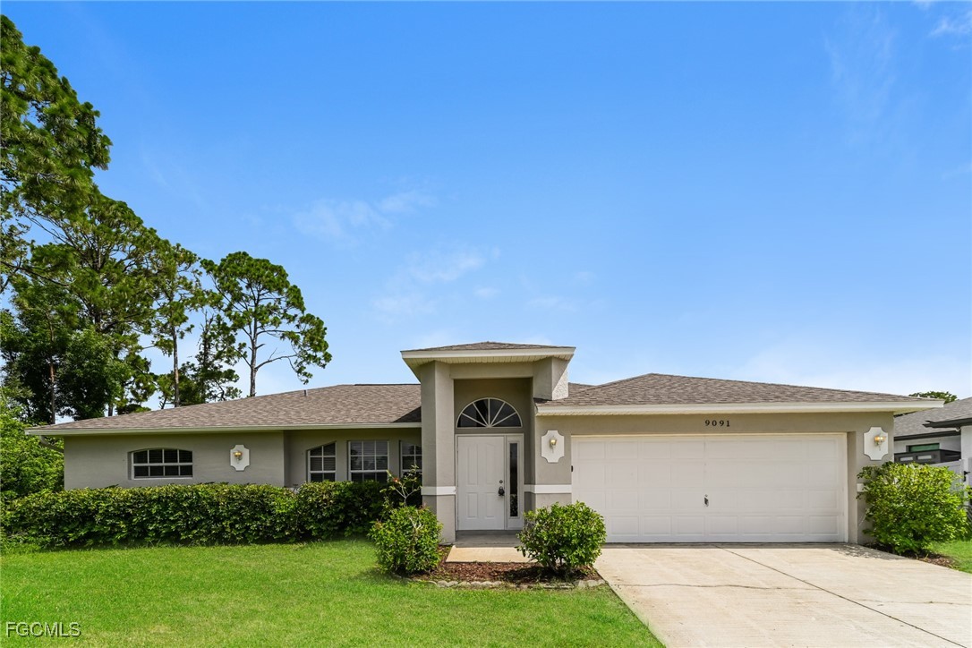 9091 Morris Road Fort Myers, FL 33967 - Photo 1 of 15 a front view of a house with garden