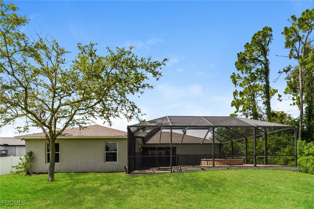 9091 Morris Road Fort Myers, FL 33967 - Photo 14 of 15 a front view of a house with garden