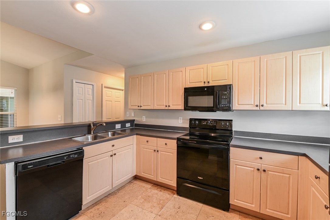 9091 Morris Road Fort Myers, FL 33967 - Photo 7 of 15 a kitchen with white cabinets appliances and a sink