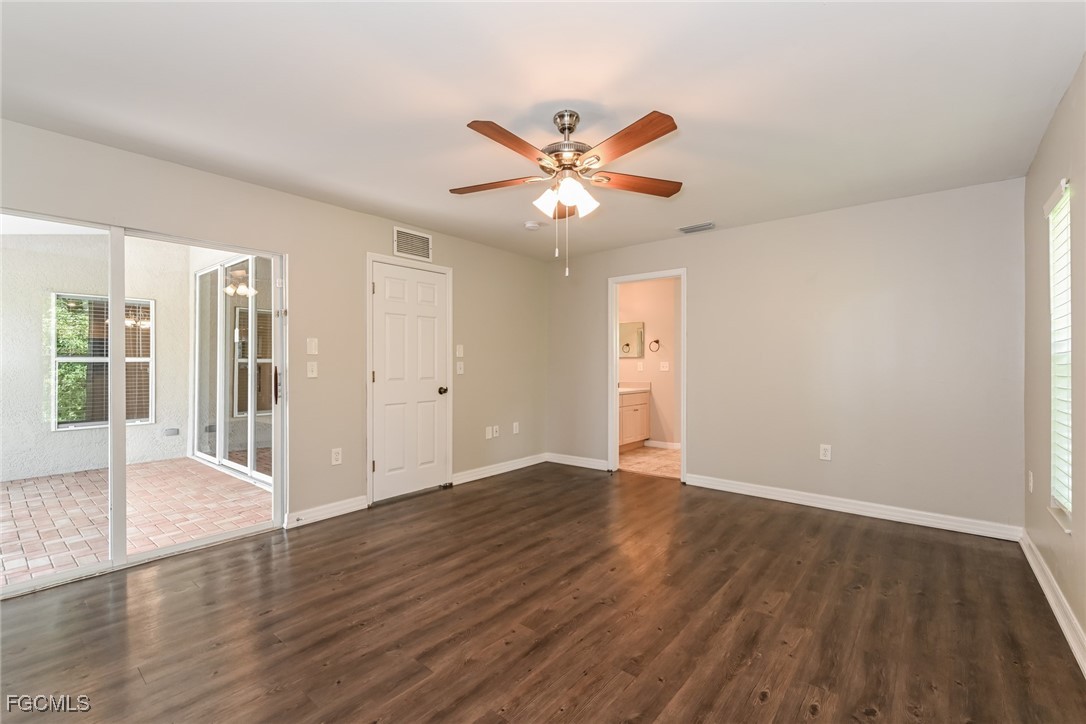 9091 Morris Road Fort Myers, FL 33967 - Photo 9 of 15 a view of an empty room with window and wooden floor