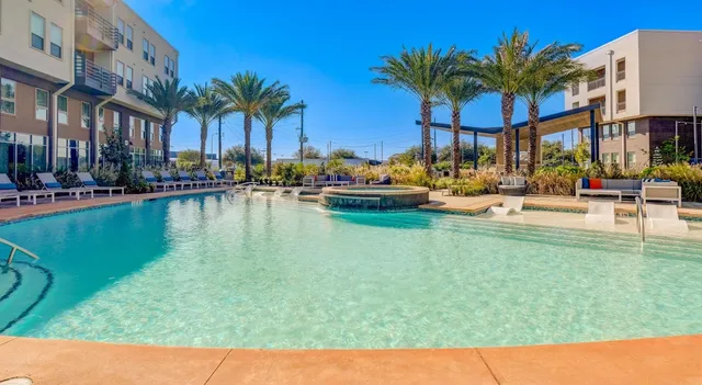 a view of swimming pool with outdoor seating and a patio