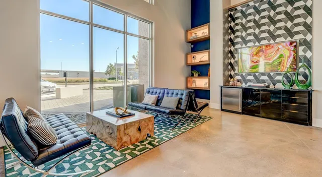 a living room with furniture and a floor to ceiling window